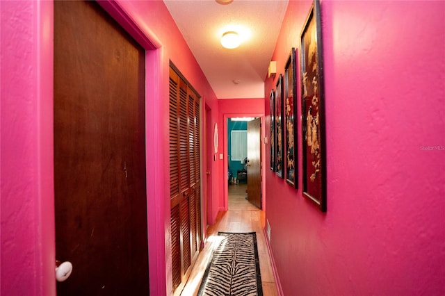 corridor featuring a textured ceiling