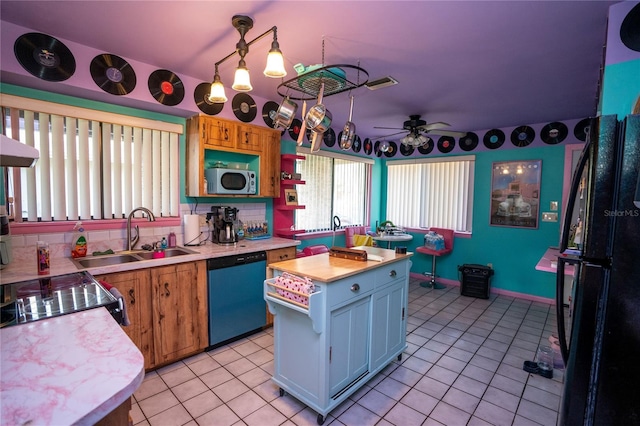 kitchen with ceiling fan, sink, a kitchen island, stainless steel dishwasher, and white cabinets