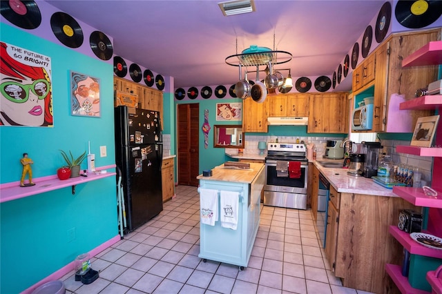 kitchen with backsplash, light tile patterned flooring, stainless steel appliances, and wood counters