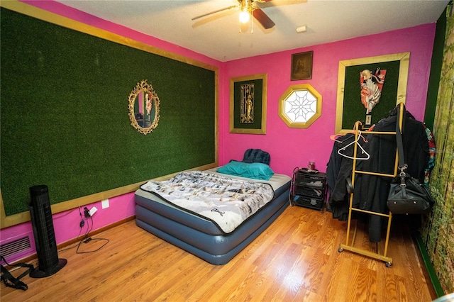 bedroom with ceiling fan and hardwood / wood-style floors