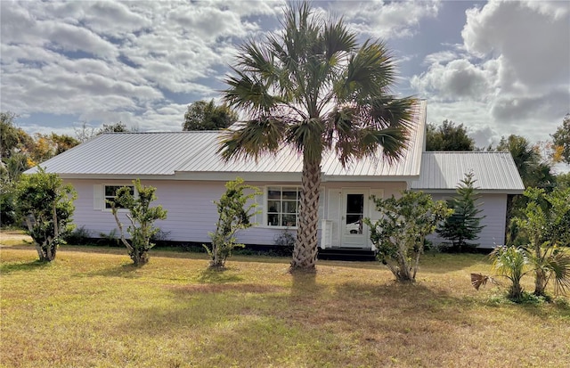 rear view of property with a lawn