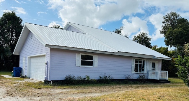 rear view of house with a garage