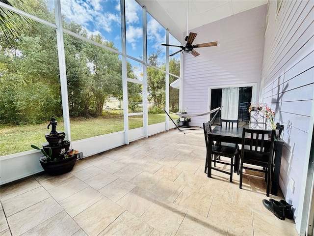 sunroom featuring ceiling fan