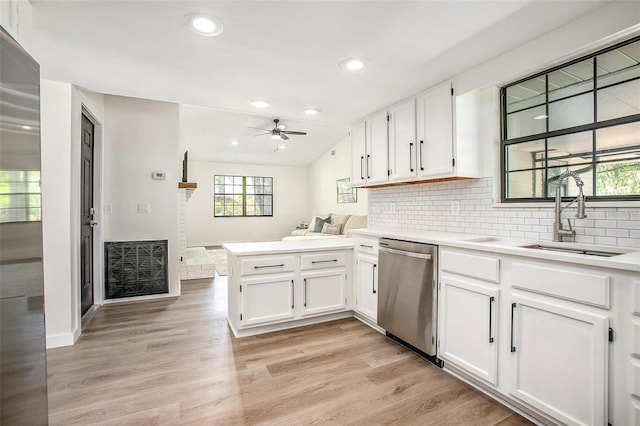 kitchen featuring white cabinetry, dishwasher, and light hardwood / wood-style floors