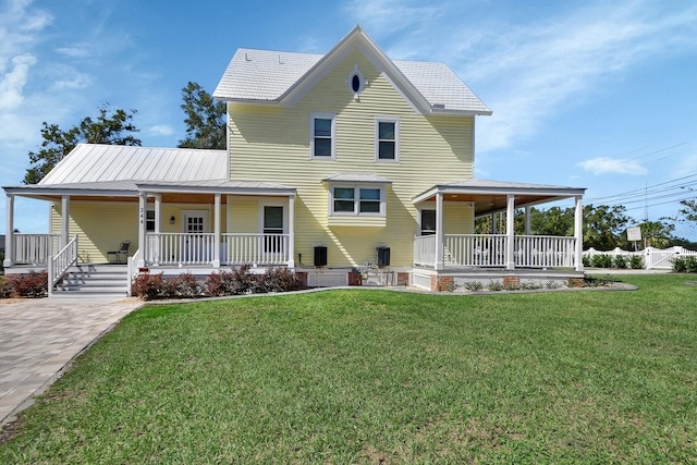 farmhouse-style home featuring covered porch and a front lawn