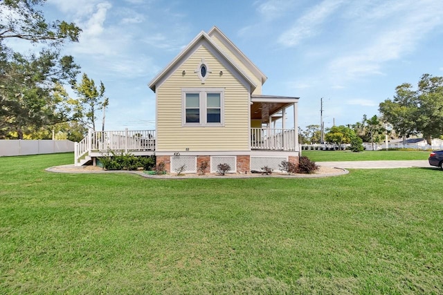 rear view of house with a yard and a deck