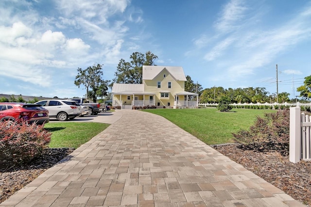 view of front of home featuring covered porch and a front yard