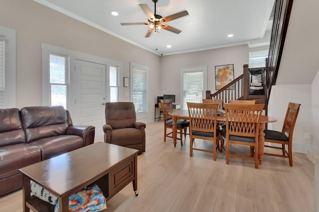 living room featuring light hardwood / wood-style floors, ceiling fan, and ornamental molding