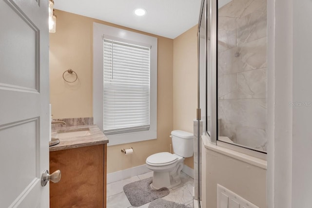 bathroom with tile patterned flooring, vanity, and toilet