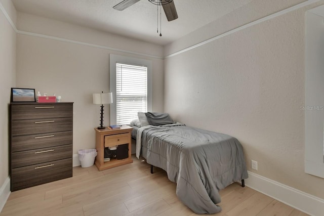 bedroom featuring ceiling fan and light hardwood / wood-style flooring