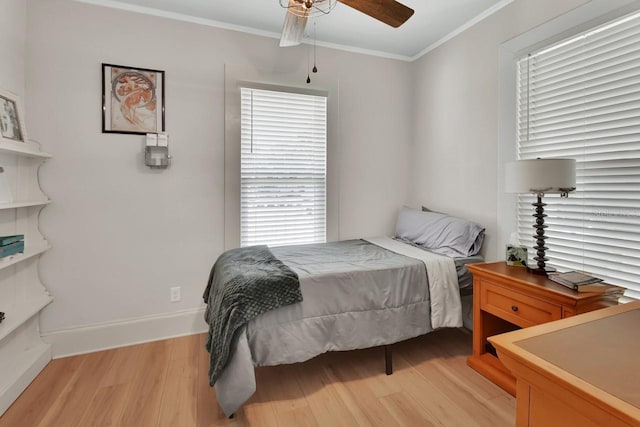 bedroom with ceiling fan, crown molding, and light hardwood / wood-style flooring