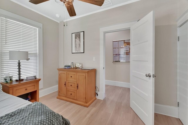 bedroom featuring light wood-type flooring, ceiling fan, and ornamental molding