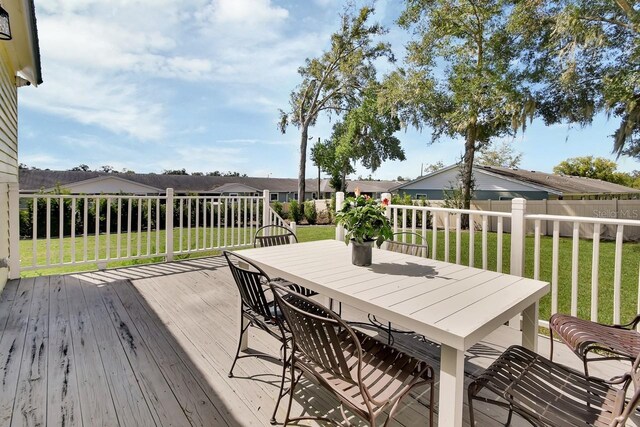 wooden deck with a lawn