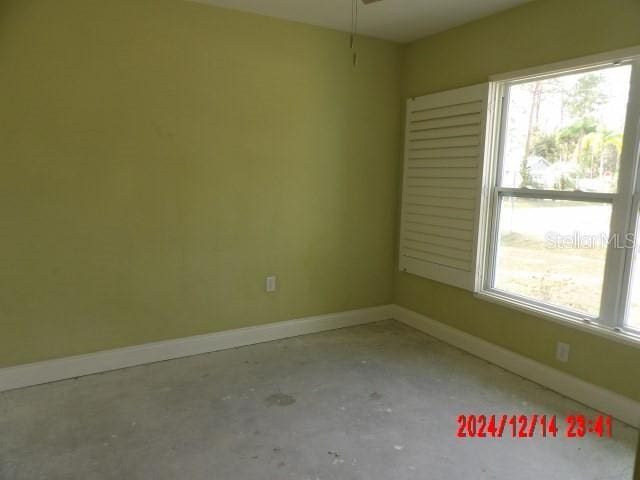 unfurnished room with concrete floors