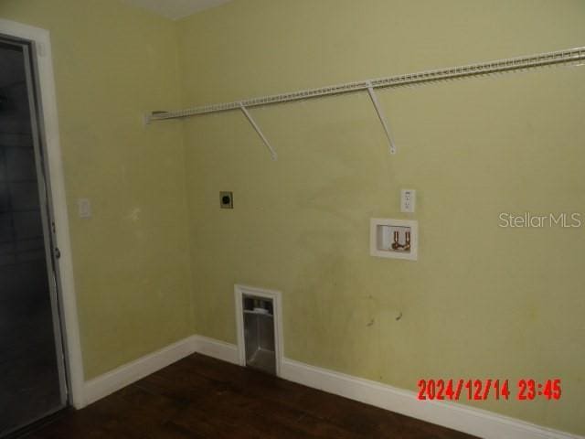 clothes washing area with hookup for a washing machine, dark hardwood / wood-style floors, and electric dryer hookup