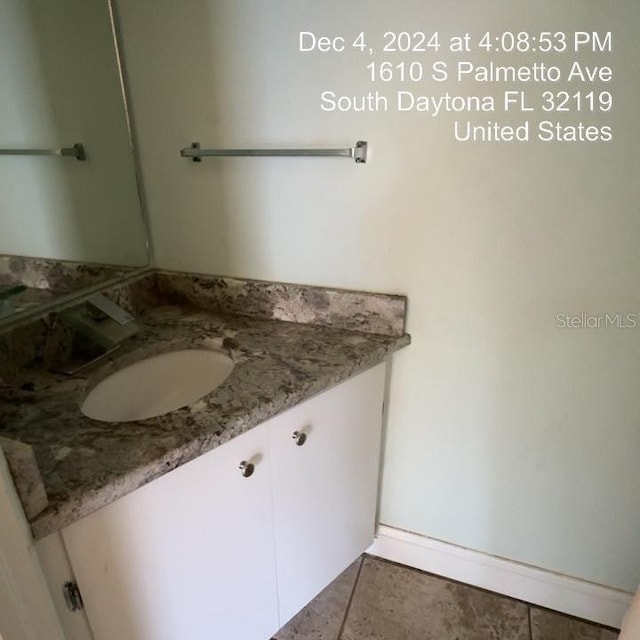 bathroom featuring tile patterned flooring and vanity