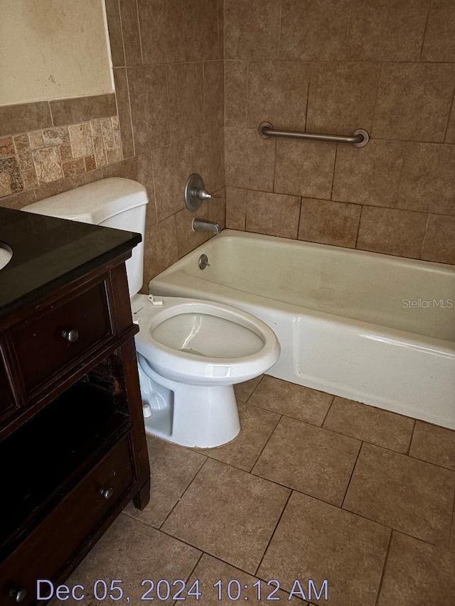 full bathroom featuring vanity, toilet, tile walls, and bathing tub / shower combination