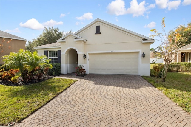 ranch-style house featuring a front yard and a garage