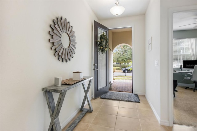 entrance foyer featuring light carpet and ceiling fan