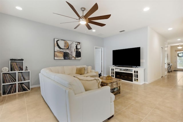 tiled living room with ceiling fan