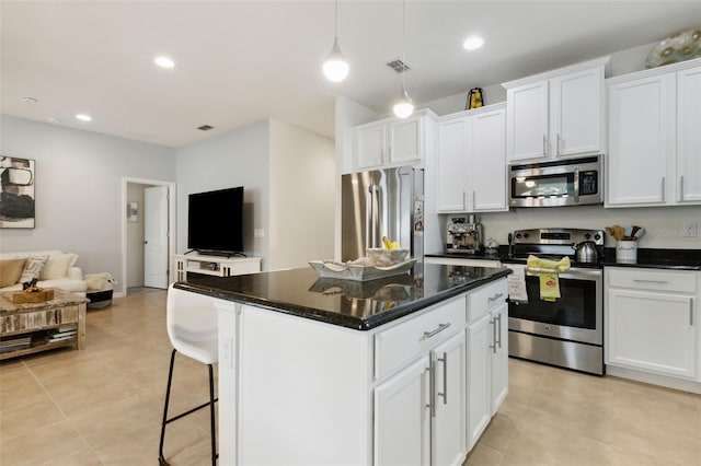 kitchen with pendant lighting, a center island, white cabinetry, and appliances with stainless steel finishes