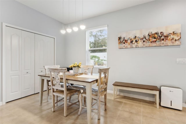 dining space featuring light tile patterned floors