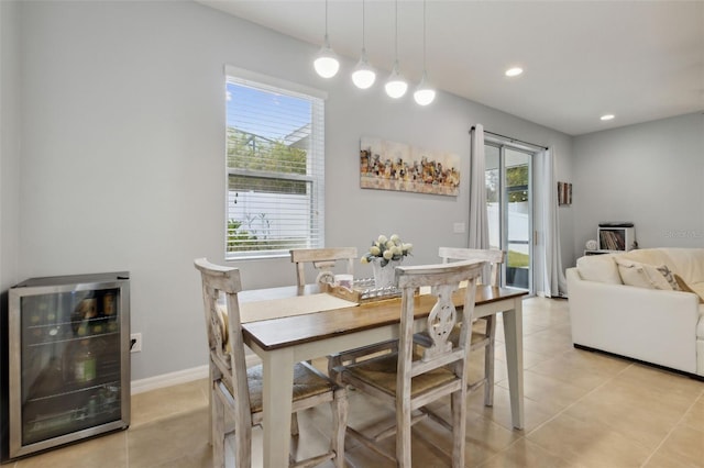 dining area featuring light tile patterned floors and wine cooler