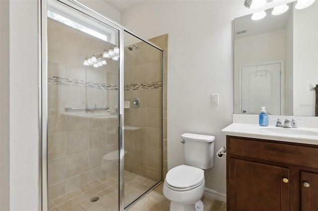 bathroom featuring vanity, toilet, and a shower with door