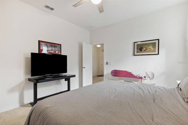 bedroom with ceiling fan and light carpet