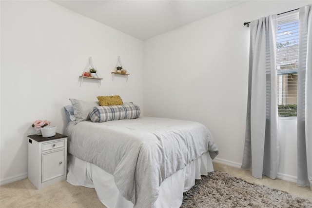 bedroom featuring light carpet