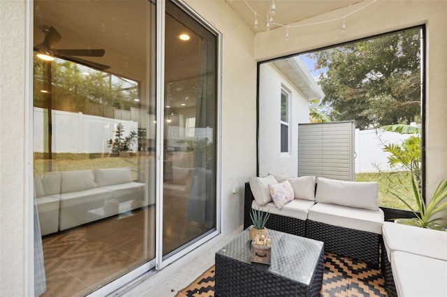 sunroom / solarium featuring ceiling fan