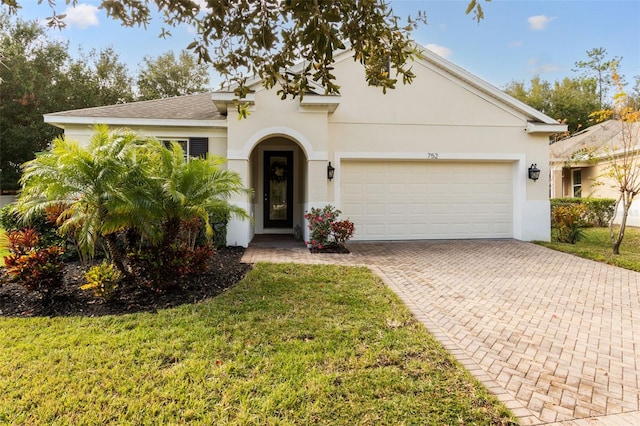 view of front of house with a front lawn and a garage