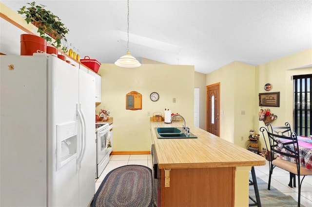 kitchen featuring sink, decorative light fixtures, white appliances, light tile patterned flooring, and kitchen peninsula