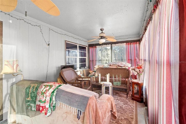 sunroom featuring ceiling fan