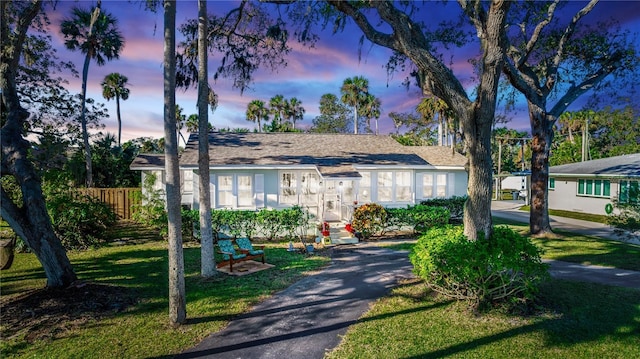 ranch-style home with a lawn