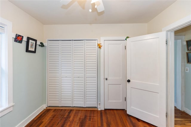 unfurnished bedroom featuring ceiling fan and dark hardwood / wood-style flooring