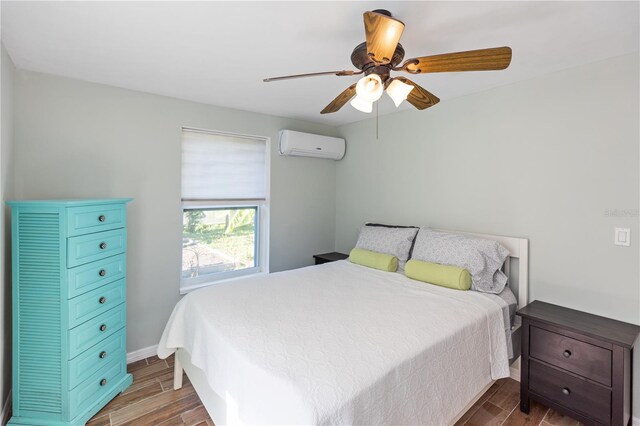 bedroom with an AC wall unit, ceiling fan, and dark hardwood / wood-style floors