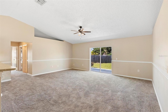 unfurnished room featuring carpet flooring, ceiling fan, a textured ceiling, and vaulted ceiling