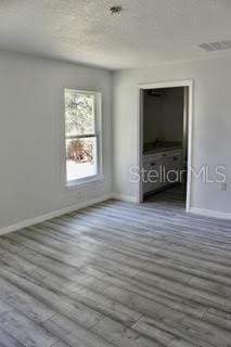 unfurnished room with hardwood / wood-style flooring