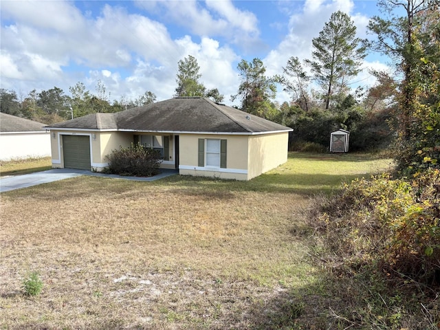 single story home with a front lawn, a garage, and a storage unit