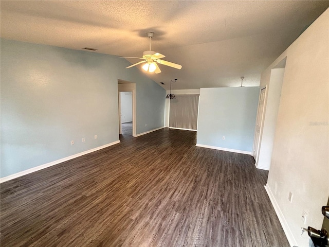 unfurnished room with vaulted ceiling, ceiling fan, dark hardwood / wood-style flooring, and a textured ceiling