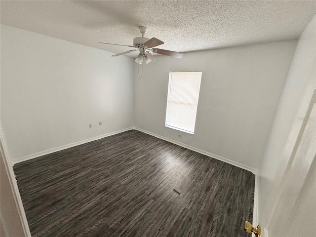 empty room with a textured ceiling, dark hardwood / wood-style flooring, and ceiling fan