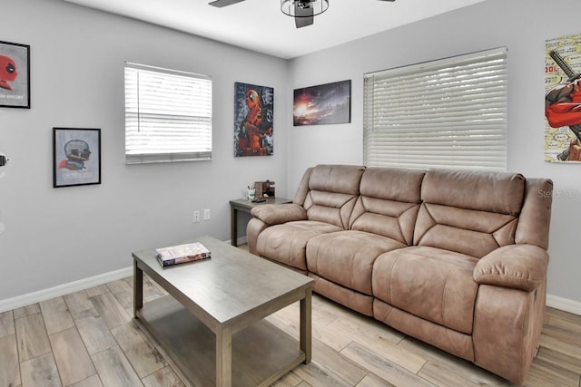 living room featuring ceiling fan and light hardwood / wood-style floors