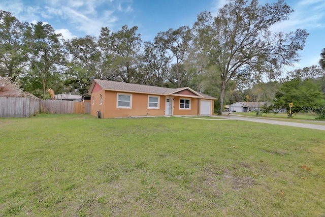 ranch-style home with a garage and a front yard