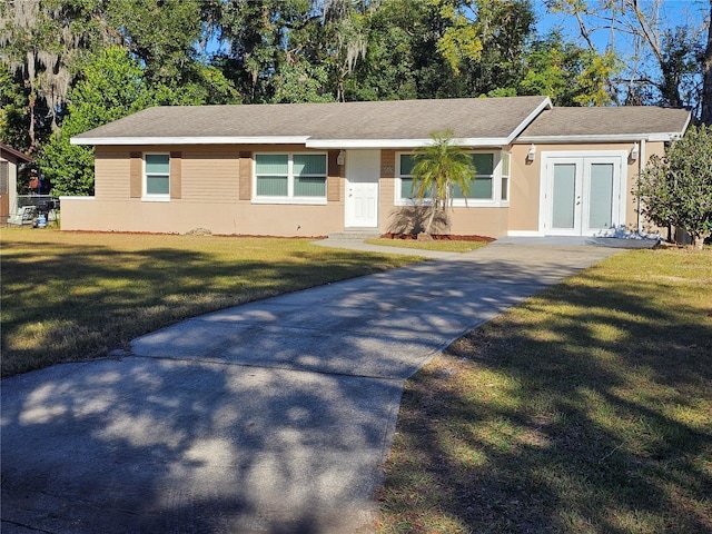 ranch-style home featuring a front yard