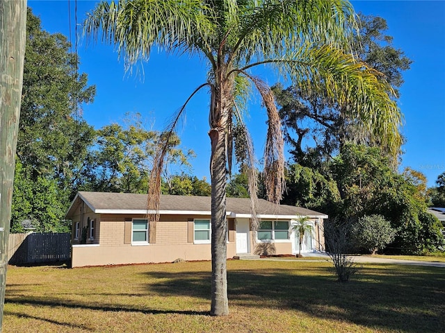 ranch-style home featuring a front yard