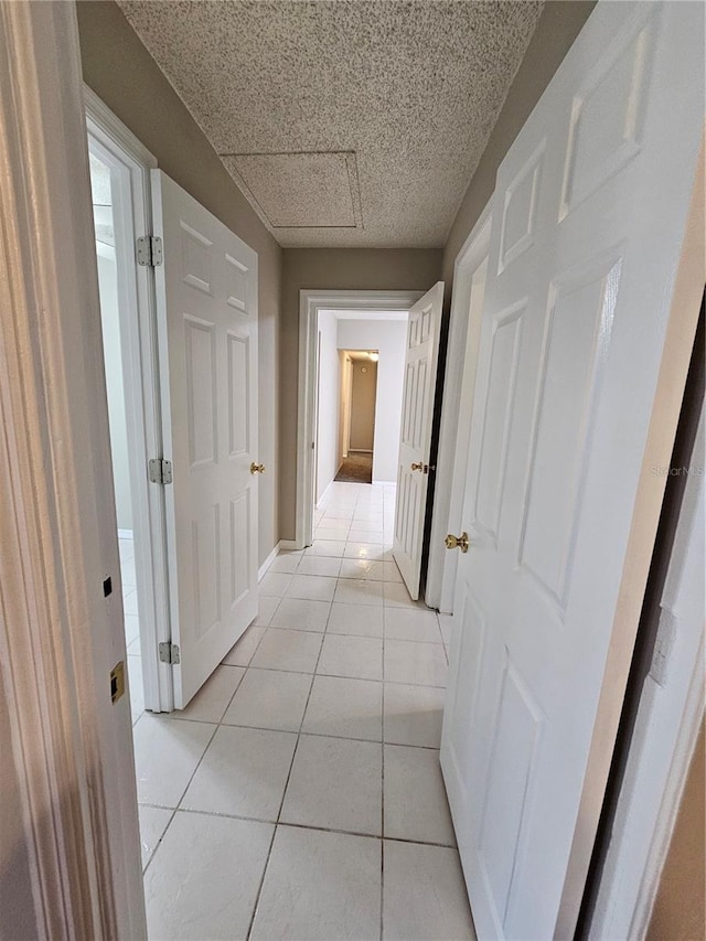 hall featuring light tile patterned floors