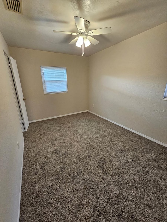 carpeted spare room featuring ceiling fan