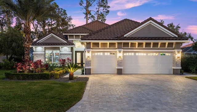 view of front of property with a lawn and a garage