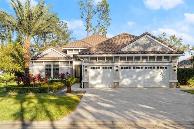 view of front facade with a front yard and a garage